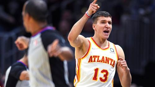 Atlanta Hawks' Bogdan Bogdanovic celebrates a turnover during the second half of the team's NBA play-in basketball game against the Cleveland Cavaliers on Friday, April 15, 2022, in Cleveland. (AP Photo/Nick Cammett)