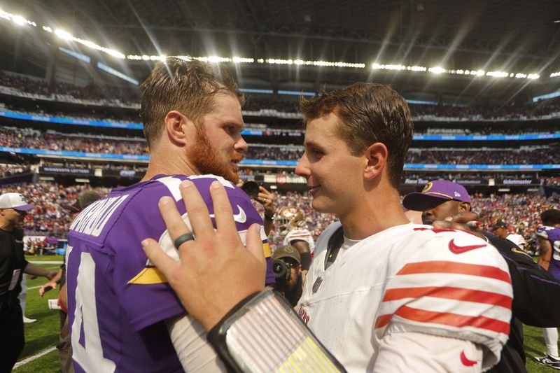 Minnesota Vikings quarterback Sam Darnold, left, talks with San Francisco 49ers quarterback Brock Purdy after an NFL football game, Sunday, Sept. 15, 2024, in Minneapolis. The Vikings won 23-17. (AP Photo/Bruce Kluckhohn)