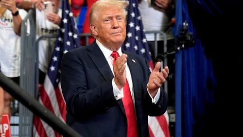 Republican presidential candidate former President Donald Trump claps at a campaign rally at Georgia State University in Atlanta, Saturday, Aug. 3, 2024. (AP Photo/John Bazemore)