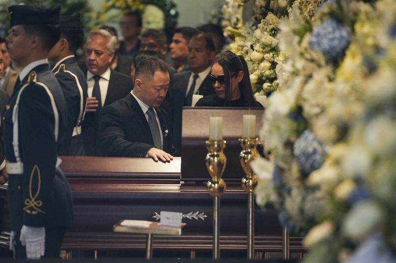 Kenji Fujimori stands by the coffin of his father, former President Alberto Fujimori, during his wake in Lima, Peru, Thursday, Sept. 12, 2024. (AP Photo/Guadalupe Pardo)