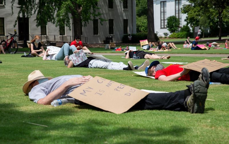 United Campus Workers of Georgia host die-in demonstration on the University of Georgia's north campus lawn outside of the Administration Building on Aug. 6, 2020 to protest UGA and the greater University System of Georgia's decision to re-open their campuses despite the onoging pandemic. KYLE PETERSON FOR THE ATLANTA JOURNAL-CONSTITUTION