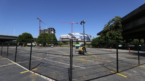 A fence is seen blocking access to the Gulch parking lot in Downtown Atlanta on Monday, July 1, 2024. Centennial Yards has begun construction on its central entertainment district, making parking unavailable on certain surface lots across much of the 50-acre property.
(Miguel Martinez / AJC)