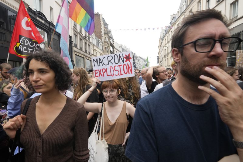 Demonstrators participate a protest, responding to a call from the far-left party who criticized as a power grab the president's appointment of a conservative new prime minister, Michel Barnier, in Paris, France, Saturday, Sept. 7, 2024. (AP Photo/Michel Euler)