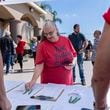 Janet Berkeley stops by a voter registration desk during a Comeback California Tour event at Revival Fellowship, Saturday, Sept. 21, 2024, in Menifee, Calif. (AP Photo/Zoë Meyers)