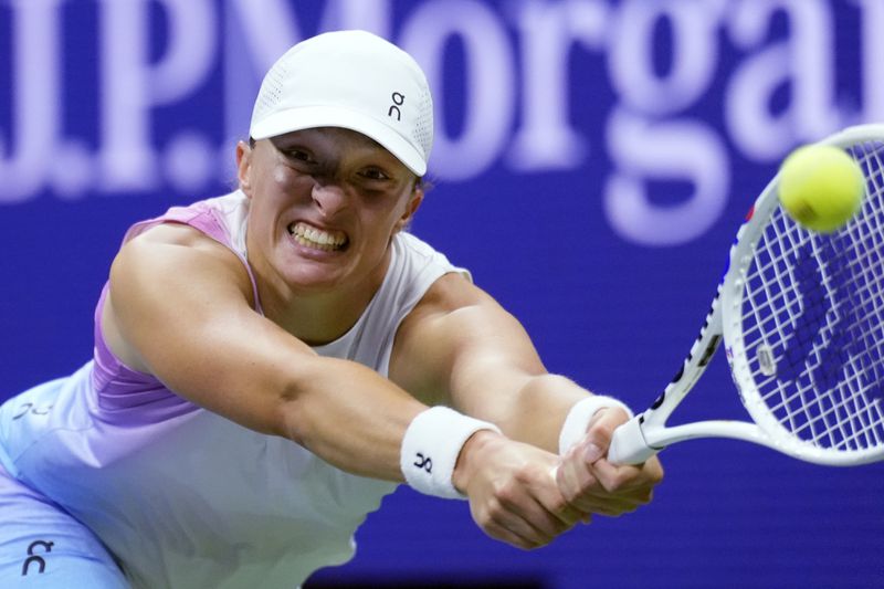 Iga Świątek, of Poland, returns to Jessica Pegula, of the United States, during the quarterfinals of the U.S. Open tennis championships, Wednesday, Sept. 4, 2024, in New York. (AP Photo/Eduardo Munoz Alvarez)