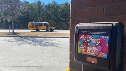 A gas station in Lawrenceville advertises fruit-flavored disposable vape devices. The devices are not authorized for sale by the FDA. The gas station is near three Gwinnett County high schools.