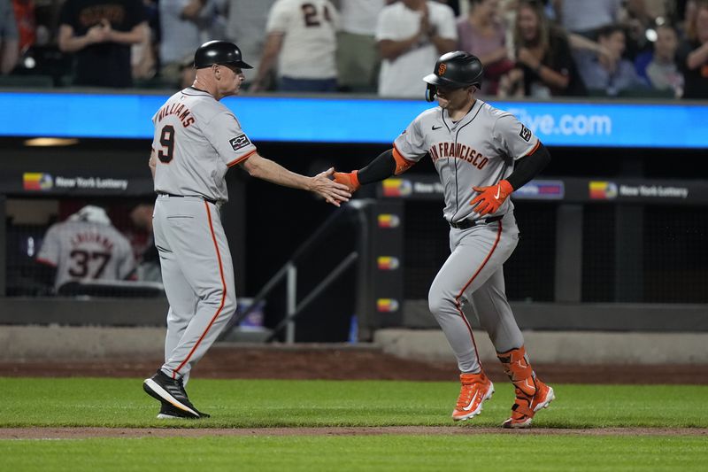 San Francisco Giants' Patrick Bailey, right, celebrates with third base coach Matt Williams as he runs the bases on a grand slam during the eighth inning of the team's baseball game against the New York Mets, Friday, May 24, 2024, in New York. (AP Photo/Frank Franklin II)