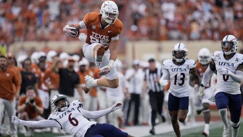 Texas tight end Gunnar Helm (85) lea[ps over UTSA safety Elliott Davison (6) during the first half of an NCAA college football game in Austin, Texas, Saturday, Sept. 14, 2024. (AP Photo/Eric Gay)