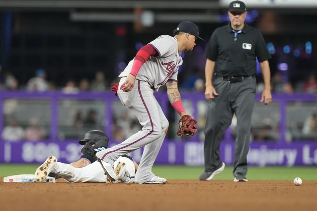 Miami Marlins' Connor Norby (24) slides into second base as Atlanta Braves shortstop Orlando Arcia (11) drops the ball during the fifth inning of a baseball game, Friday, Sept. 20, 2024, in Miami. The Braves lost 4-3. (AP Photo/Marta Lavandier)