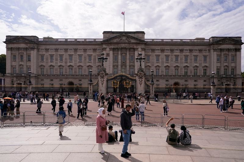 Tourists take photos and visit Buckingham Palace in London, Tuesday, Sept. 10, 2024. Kate, Princess of Wales announced Monday that she has completed chemotherapy treatment for cancer and plans to return to some public duties. (AP Photo/Alberto Pezzali)