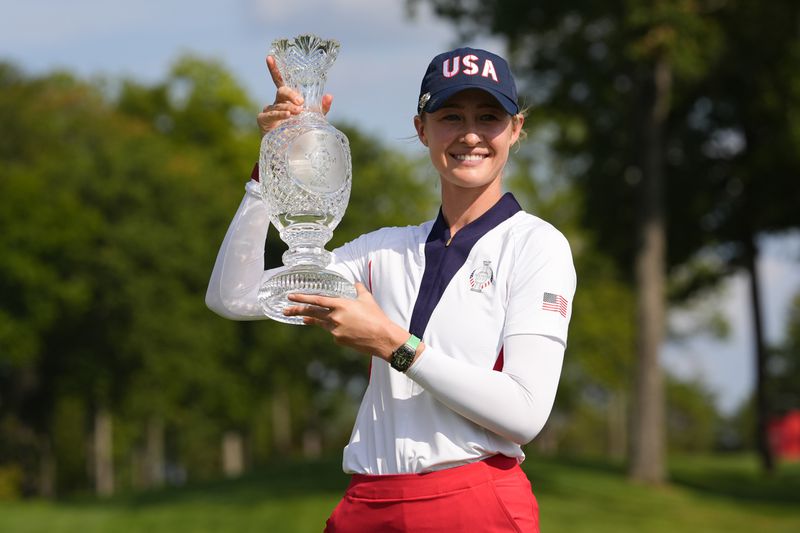 United States' Nelly Korda holds the winner's trophy after the United States defeated Europe in the Solheim Cup golf tournament at the Robert Trent Jones Golf Club, Sunday, Sept. 15, 2024, in Gainesville, Va. (AP Photo/Matt York)