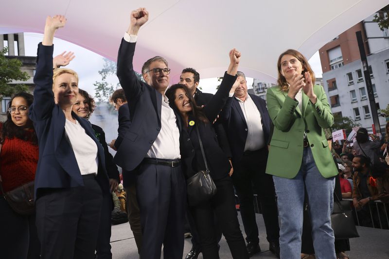FILE - Far-left politician Clementine Autain, left, President of the Green Party Marine Tondelier, right, and Socialist Party Secretary General Olivier Faure, center, raise their fist during a campaign meeting of the France's left-wing coalition known as the New Popular Front, in Montreuil, east of Paris, on June 17, 2024. From taxing billionaires and making gasoline cheaper to earlier retirement and higher wages, opposing left-right blocs in France's election are making costly campaign promises that are spooking investors as they seek to woo voters and sideline President Emmanuel Macron. (AP Photo/Thomas Padilla, File)