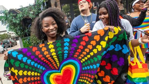 Mia Edwards, from left, and Sarai Hampton, participate in the annual Pride Parade on Sunday, Oct 15, 2023.  (Jenni Girtman for The Atlanta Journal-Constitution)