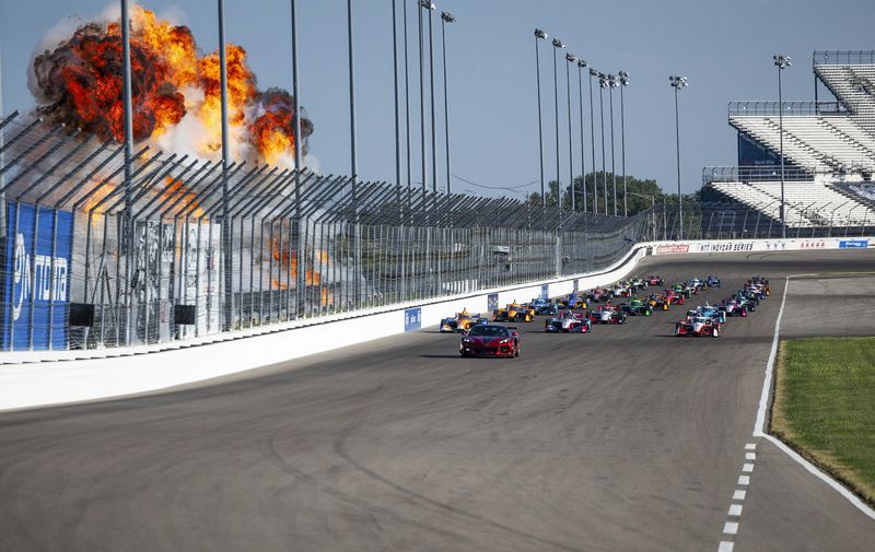 IndyCar drivers fly past a series of explosion to kick off the Bommarito Automotive Group 500 on Saturday, Aug. 17, 2024, at World Wide Technology Raceway in Madison,Ill. Josef Newgarden finished first in the race on Saturday. (Zachary Linhares/St. Louis Post-Dispatch via AP)