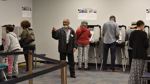October 18, 2018 Lawrenceville - Volunteer Alfred Leblanc (center) directs early voters at The Gwinnett County Voter Registrations and Elections Office in Lawrenceville on Thursday, October 18, 2018. More than 12,000 ballots had been received by the Gwinnett County Board of Voter Registration and Elections before the third day of in-person early voting had ended, county spokesman Joe Sorenson said. The county received 12,827 ballots by the end of the day Wednesday, about 45 percent of the 28,860 that have been issued for absentee by mail, advance in person, military and overseas voting. HYOSUB SHIN / HSHIN@AJC.COM