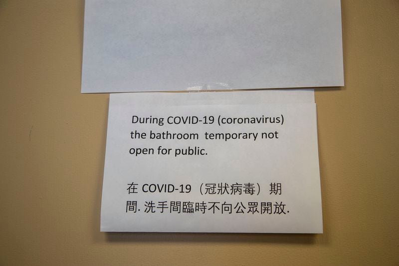 A sign, printed in multiple languages, informs customers at Family Baking that the restroom is temporarily out of order inside the Atlanta Chinatown Shopping Mall in Chamblee, Friday, July 31, 2020. (ALYSSA POINTER / ALYSSA.POINTER@AJC.COM)