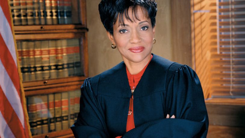 Judge Hatchett wearing a purple gown.