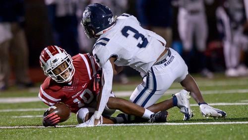 Hillgrove's Reggie Givhan (10) is tackled by Marietta's Milon Jones (3) after Givhan intercepted a pass in the second half of their game Friday, October 30, 2020. PHOTO/Daniel Varnado