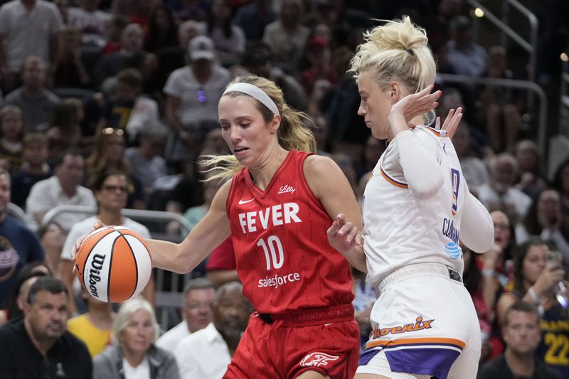 Indiana Fever's Lexie Hull (10) is defended by Phoenix Mercury's Sophie Cunningham, right, during the second half of a WNBA basketball game, Friday, Aug. 16, 2024, in Indianapolis. (AP Photo/Darron Cummings)