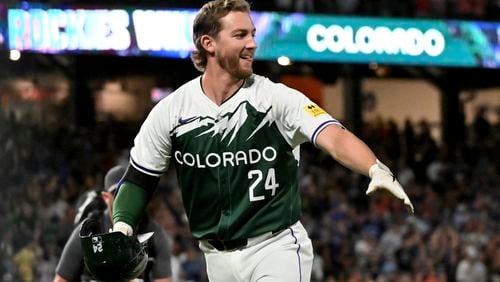 Colorado Rockies' Ryan McMahon celebrates after he was walked with the bases loaded to give the Rockies a win against the Washington Nationals in a baseball game Saturday, June 22, 2024, in Denver. (AP Photo/Geneva Heffernan)