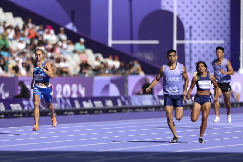 Italy's Valentina Petrillo competes in the women's 400m T12 round 1, at the Stade de France stadium, during the 2024 Paralympics, Monday, Sept. 2, 2024, in Paris, France. (AP Photo/Jackson Ranger)