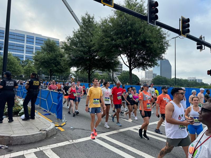 Last wave of runners head to the start line of the AJC Peachtree Road Race to get started.