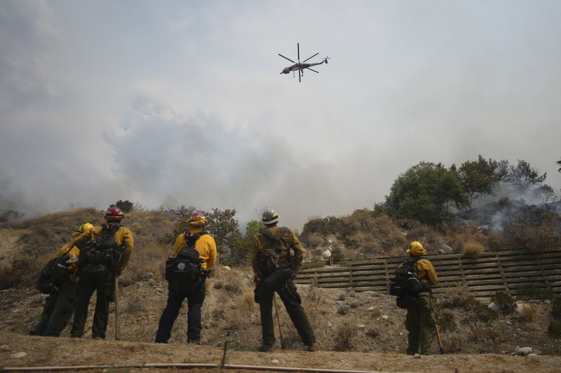 Fire crews monitor the Line Fire Saturday, Sept. 7, 2024, in Highland, Calif. (AP Photo/Eric Thayer)