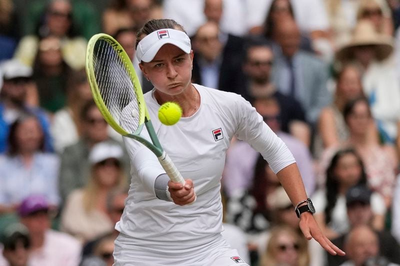 Barbora Krejcikova of the Czech Republic plays a forehand return to Jasmine Paolini of Italy during the women's singles final at the Wimbledon tennis championships in London, Saturday, July 13, 2024. (AP Photo/Mosa'ab Elshamy)