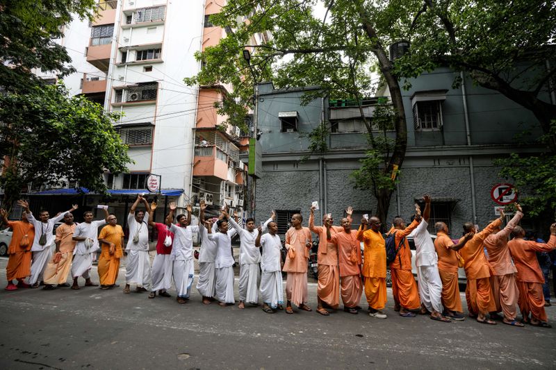 Members of the International Society for Krishna Consciousness wait in a queue to cast their votes outside a polling station during the seventh and last phase of general election, in Kolkata, India, Saturday, June 1, 2024. (AP Photo/Bikas Das)
