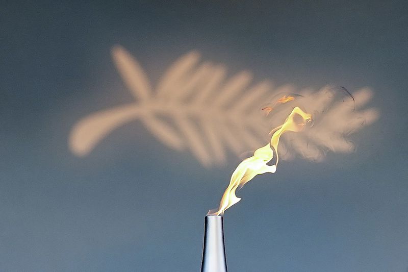 The Olympic flame is seen prior to the premiere of the film 'Marcello Mio' at the 77th international film festival, Cannes, southern France, Tuesday, May 21, 2024. (Photo by Daniel Cole/Invision/AP)