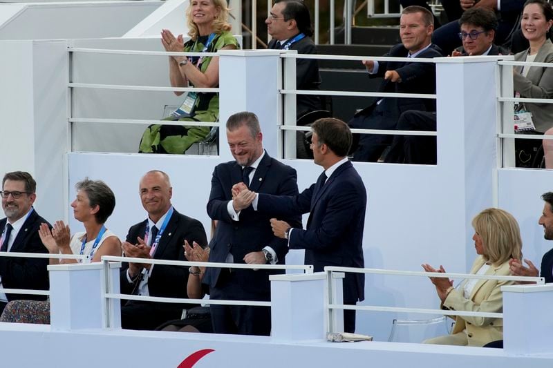 French President Emmanuel Macron, right, and IPC president Andrew Parson shake hands during the Opening Ceremony for the 2024 Paralympics, Wednesday, Aug. 28, 2024, in Paris, France. (AP Photo/Emilio Morenatti)