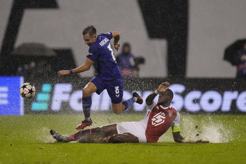 Dinamo's Lukas Kacavenda escapes the tackle by Monaco's Denis Zakaria during the Champions League soccer match between Dinamo Zagreb and Monaco at Maksimir stadium in Zagreb, Croatia, Wednesday, Oct. 2, 2024. (AP Photo/Darko Bandic)