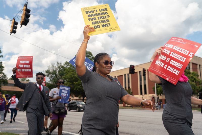 Endeavor Air flight attendants demonstrate outside of Delta headquarters in Atlanta. Demonstrators held signs and yelled chants demanding an end to tiered treatment. Thursday, Oct. 3, 2024. (Ben Hendren for the Atlanta Journal-Constitution)