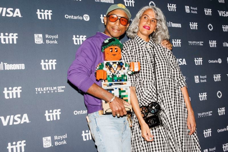 Pharrell Williams and Mimi Valdez arrive on the red carpet for the premiere of 'Piece by Piece' at the Princess of Wales Theatre during the Toronto International Film Festival in Toronto, Tuesday, Sept. 10, 2024. (Cole Burston/The Canadian Press via AP)