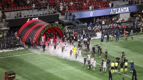 San Jose and Atlanta United players enter the pitch before the MLS season opener at Mercedes-Benz Stadium, Saturday, Feb. 25, 2023, in Atlanta. Jason Getz / Jason.Getz@ajc.com)
