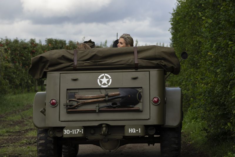 Dutch Queen Maxima looks back from a jeep during a ceremony marking the 80th anniversary of the liberation of the south of the Netherlands in Mesch, Thursday, Sept. 12, 2024. (AP Photo/Peter Dejong, Pool)