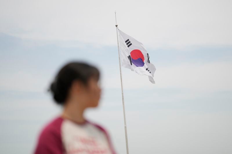 A South Korean national flag flutters in the wind at the unification observatory in Paju, South Korea, Friday, June 21, 2024. On Friday, South Korea’s military said it had fired warnings shots the previous day to repel several North Korean soldiers who briefly crossed the military demarcation line that divides the countries while engaging in unspecified construction work. Because of an overgrowth of foliage, the North Koreans may not have seen the signs marking the thin military demarcation line that divides the DMZ into northern and southern sides since the 1950-53 Korean War. (AP Photo/Lee Jin-man)