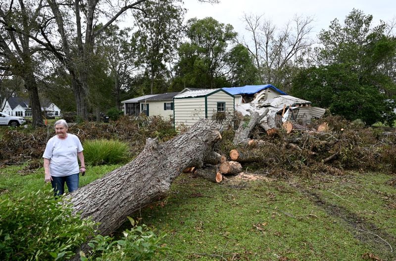 Linda Hall shows the damage caused by Hurricane Helene at the home of her daughter in Alapaha, Ga.