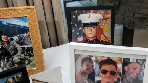 Photographs of Marine Corporal Spencer R. Collart and his fellow marines, Marine Corps Captain Eleanor V. LeBeau, bottom left, and Marine Corps Major Tobin J. Lewis, bottom right, are seen at the home of his parents in Arlington, Va., Thursday, June 19, 2024. Collart, 21, was killed along with the two Marines when the MV-22B Osprey aircraft they were on crashed during drills on a north Australian island on August 27, 2023. (AP Photo/Rod Lamkey, Jr.)