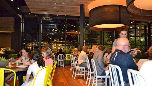 In keeping with the healthy lifestyle angle, True Food Kitchen features a light and airy dining room outfitted with trendy, minimalist sensibilities and a stunning windowed wall overlooking Buckhead. Photo by Jenny Turknett