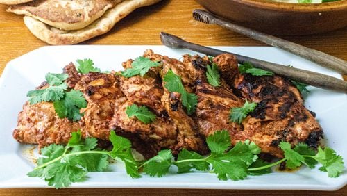 A marinade of tandoori paste, yogurt and lime juice provide delicious flavor to chicken thighs. 
(Virginia Willis for The Atlanta Journal-Constitution)