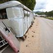 A trailer moved by floodwater sits on the side of a road in the aftermath of Hurricane Helene, Thursday, Oct. 3, 2024, in Pensacola, N.C. (AP Photo/Mike Stewart)