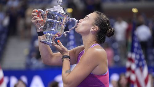 Aryna Sabalenka, of Belarus, kisses the trophy after winning the women's singles final of the U.S. Open tennis championships against Jessica Pegula, of the United States, , Saturday, Sept. 7, 2024, in New York. (AP Photo/Frank Franklin II)