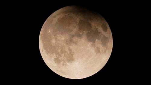 FILE - A supermoon with a partial lunar eclipse rises over Lake Michigan in Chicago, Tuesday, Sept. 17, 2024. (AP Photo/Kiichiro Sato, File)