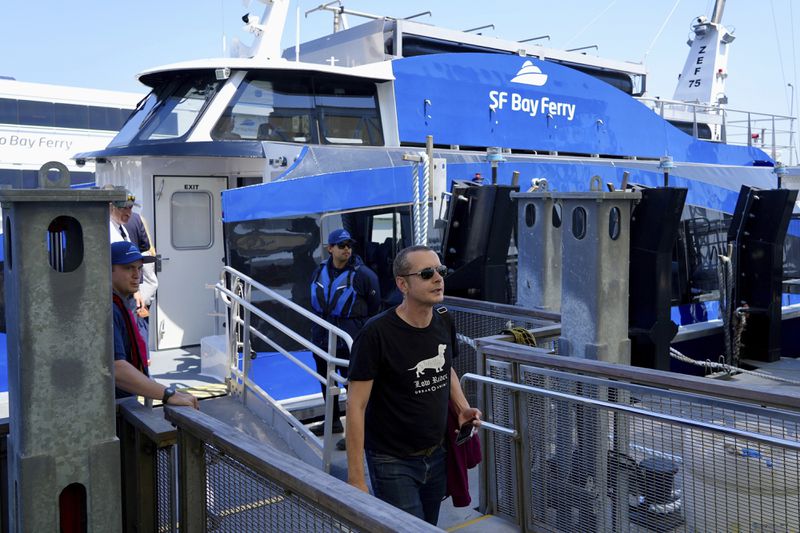 A person walks off the MV Sea Change, the first commercial passenger ferry powered by hydrogen fuel cells, Friday, July 12, 2024, in San Francisco. The MV Sea Change will begin offering free rides to the public along the San Francisco waterfront on Friday, July 19. (AP Photo/Terry Chea)