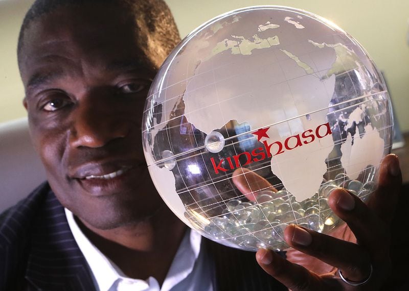 June 7, 2017, Atlanta: Dikembe Mutombo poses for a portrait in his office with a globe marking the site of the Biamba Maria Mutombo Hospital in Kinshasa at the Dikembe Mutombo Foundation, Inc., on Wednesday, June 7, 2017, in Atlanta.     Curtis Compton/ccompton@ajc.com