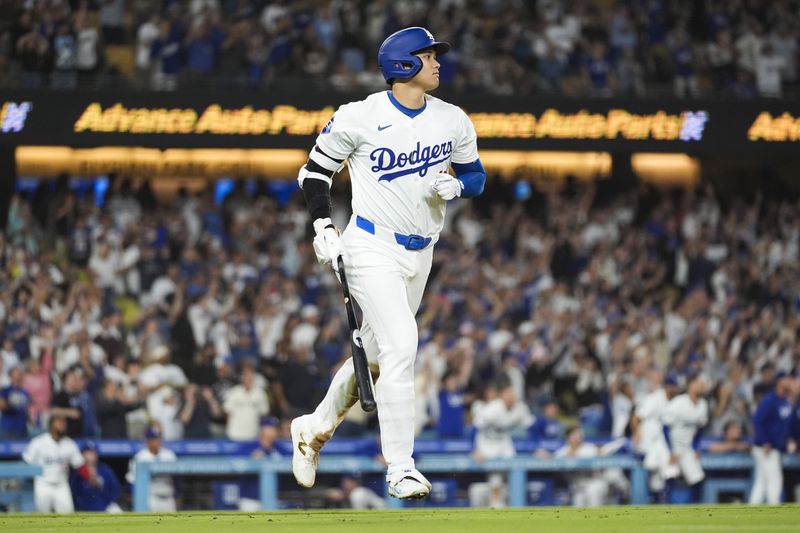 Los Angeles Dodgers designated hitter Shohei Ohtani (17) hits a grand slam during the ninth inning of a baseball game against the Tampa Bay Rays in Los Angeles, Friday, Aug. 23, 2024. The Dodgers won 7-3. Will Smith, Tommy Edman, and Max Muncy also scored. (AP Photo/Ashley Landis)