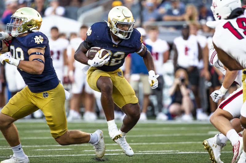 Notre Dame running back Devyn Ford (22) finds a gap during the second half of an NCAA college football game against Miami (Ohio), Saturday, Sept. 21, 2024, in South Bend, Ind. (AP Photo/Michael Caterina)