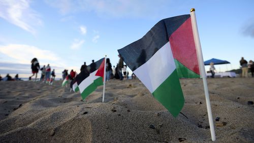 Palestinian flags are seen during a vigil on Alki Beach for Aysenur Ezgi Eygi, a 26-year-old activist from Seattle, who was killed recently in the West Bank, Wednesday, Sept. 11, 2024, in Seattle. (AP Photo/John Froschauer)