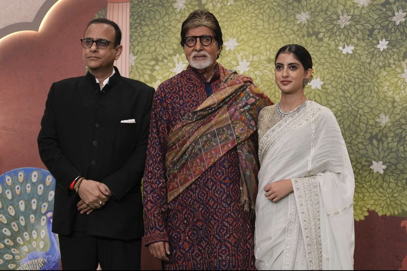 Indian actor Amitabh Bachchan, center, Navya Nanda, right and Nikhil Nanda pose for a picture during the blessing ceremony of newly wed couple Anant Ambani son of billionaire Mukesh Ambani's and his wife Radhika Merchant at Jio World Convention Centre in Mumbai, India, Saturday, July 13, 2024.(AP Photo /Rajanish Kakade)